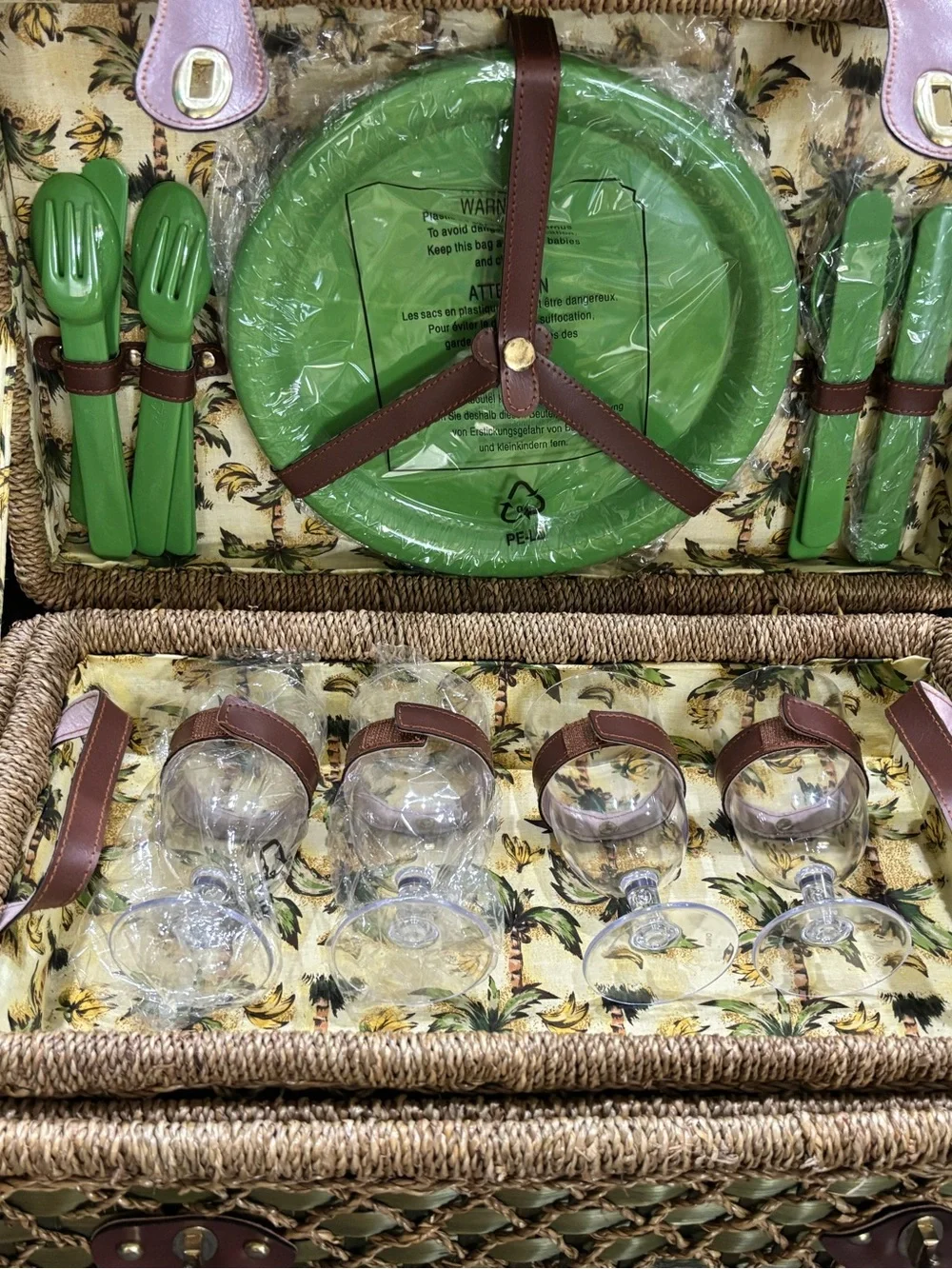 Vintage wicker and tropical palm green picnic basket service for four